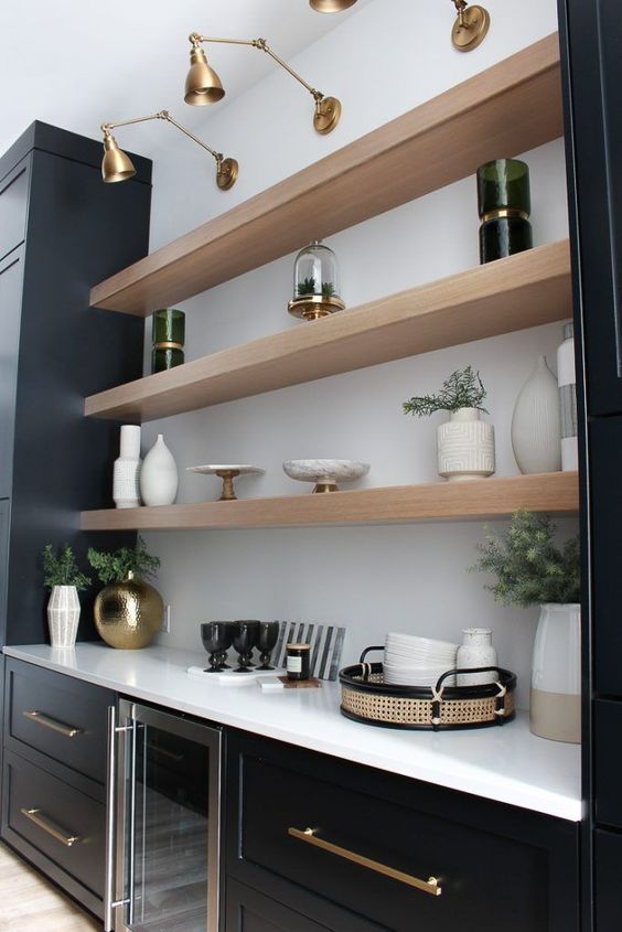 floating shelves between black cabinets