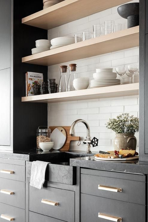 floating shelves between black cabinets