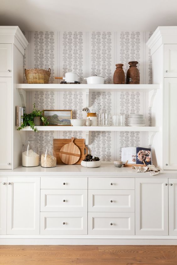 long white floating shelves between cabinets