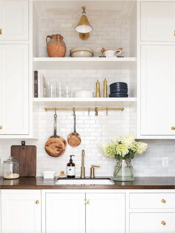 white floating shelves between cabinets