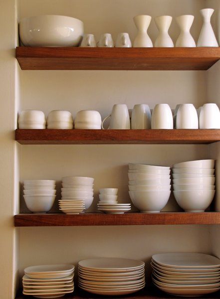 Dishware on kitchen floating shelves