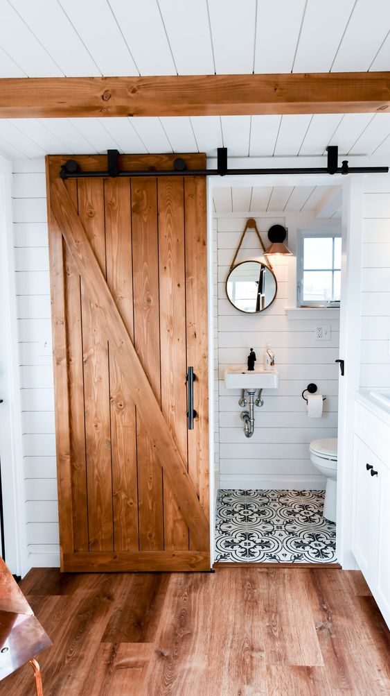 barn doors in tiny house bathroom